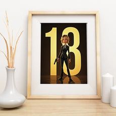 Framed print of animated woman in suit holding gun with golden 18 numbers in background